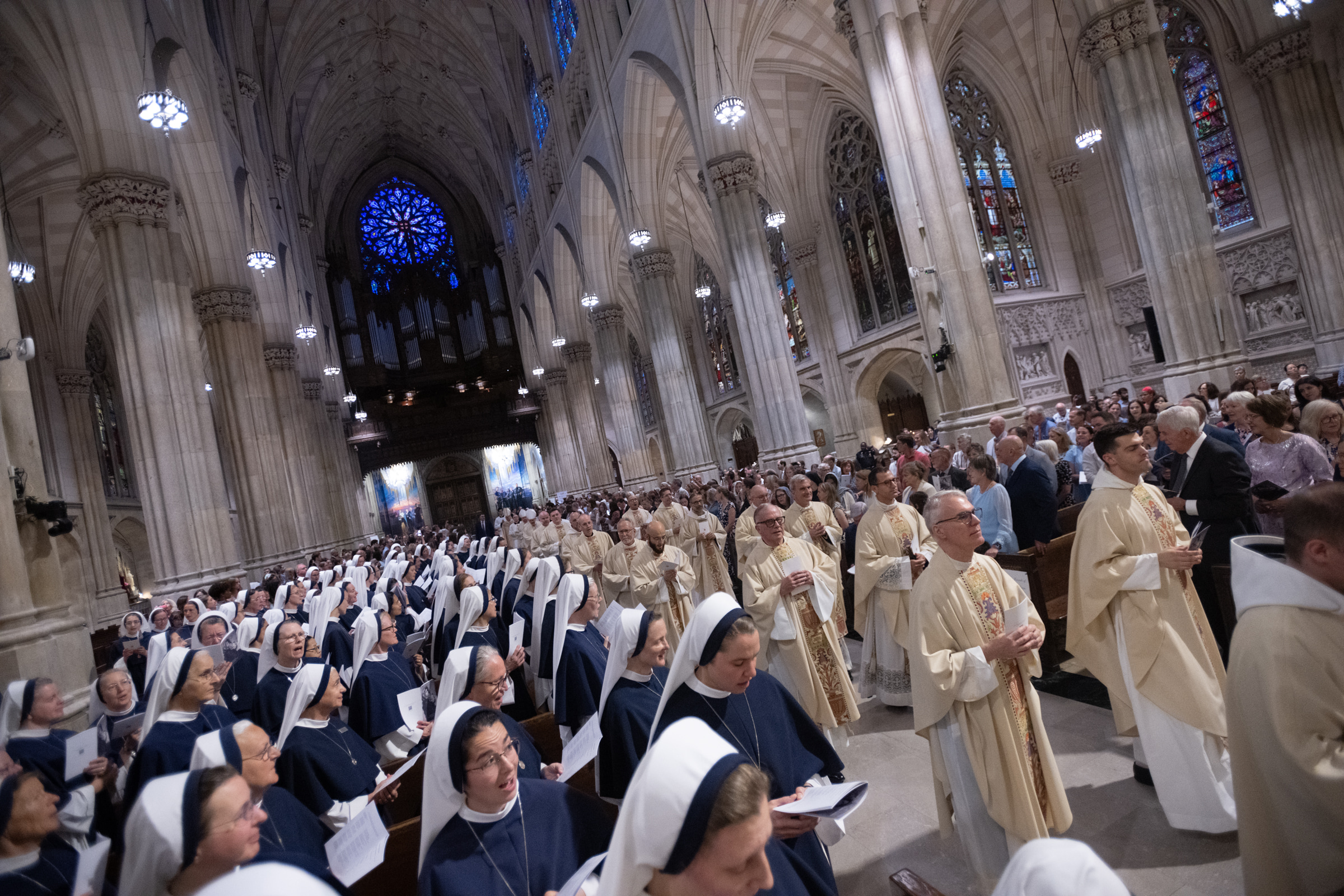 Priests process through the nave as Sisters of Life sing from the pews.
