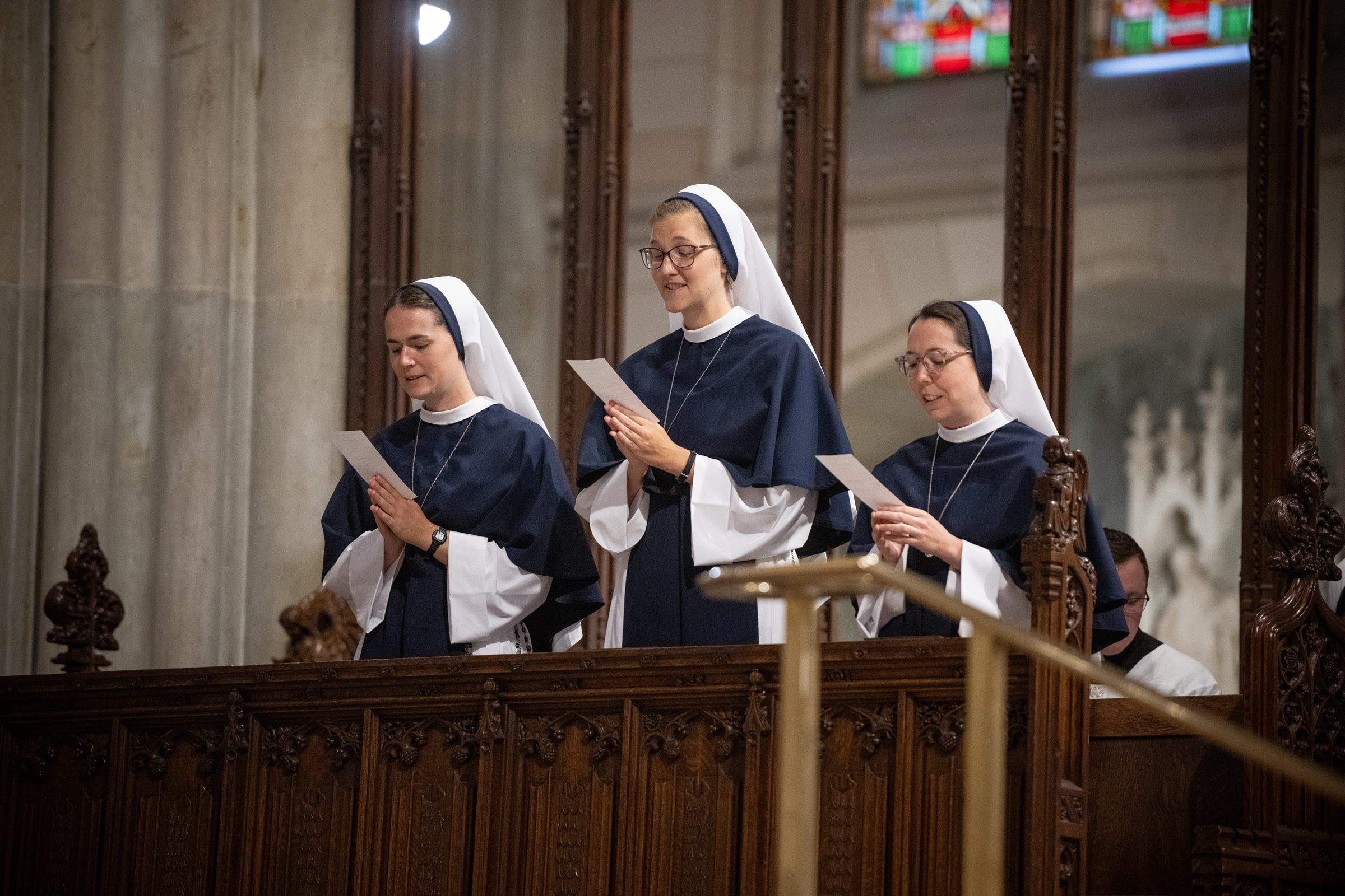 From left: Sister Maria Annunciata, S.V.; Sister Elena Marie, S.V.; and Sister Eden Marie, S.V., read together from prayer cards.