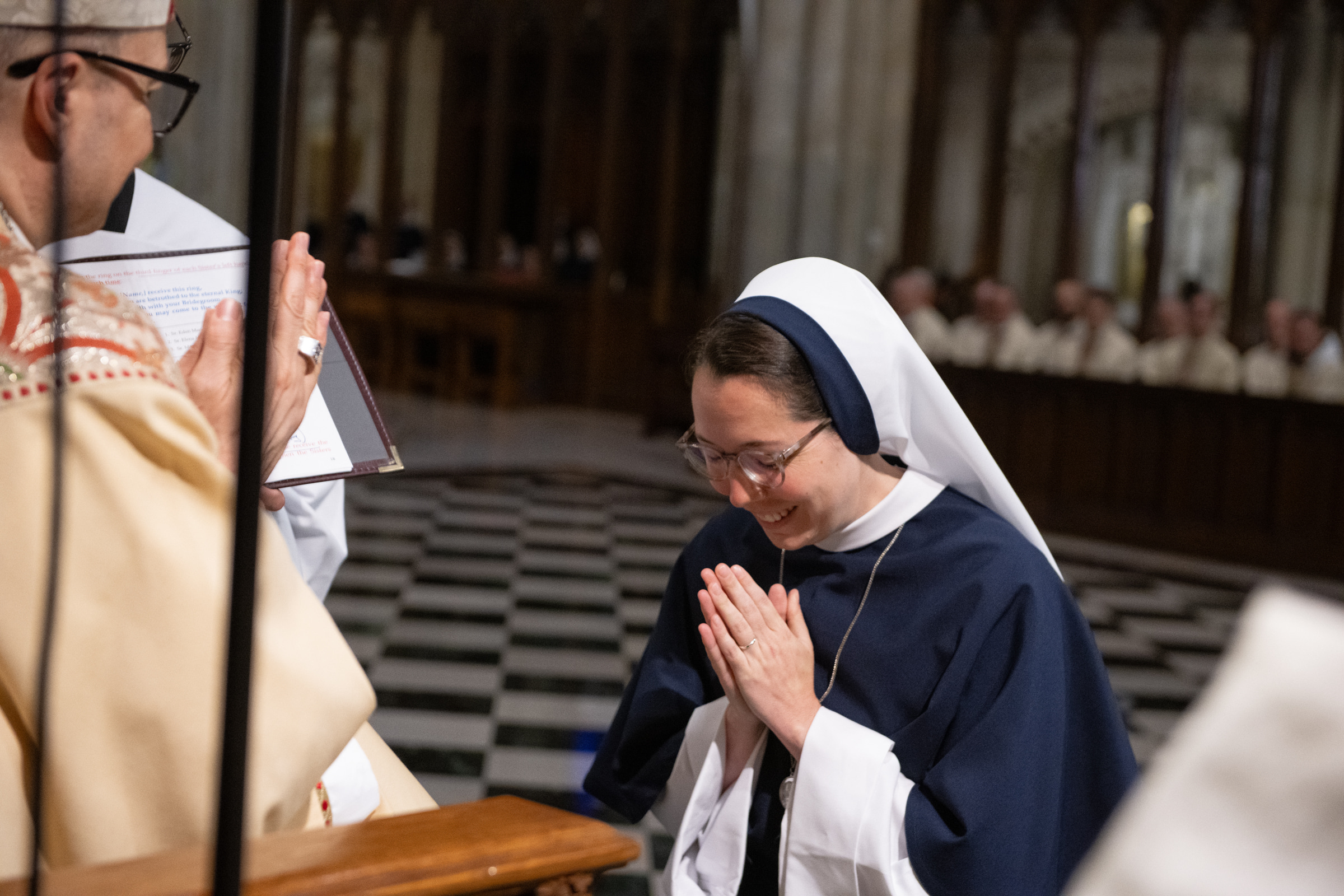 Sister Eden Marie, S.V., bows in prayer after receiving her profession ring from Archbishop Hicks.