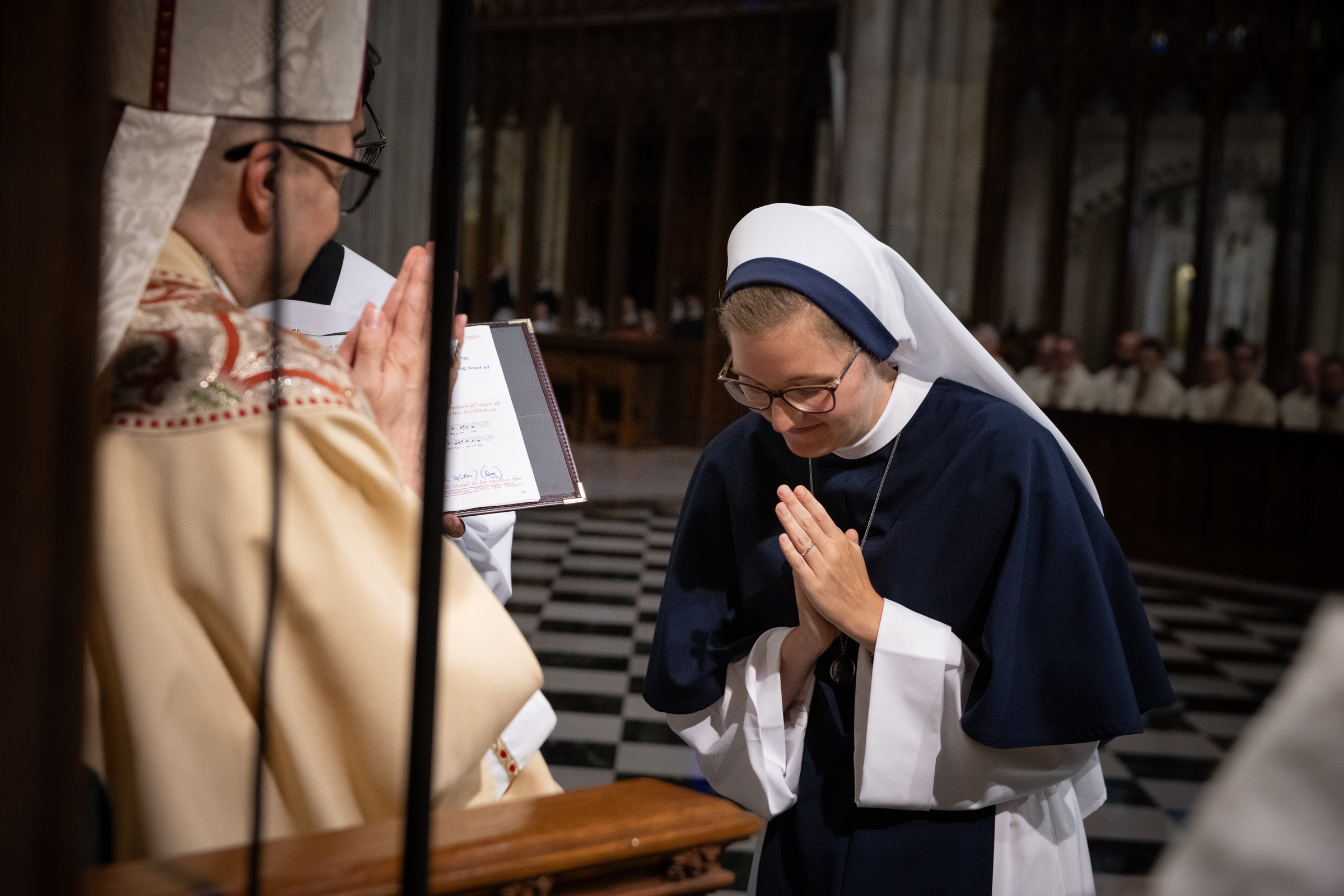 Sister Elena Marie, S.V., bows in prayer after receiving her profession ring from Archbishop Hicks.