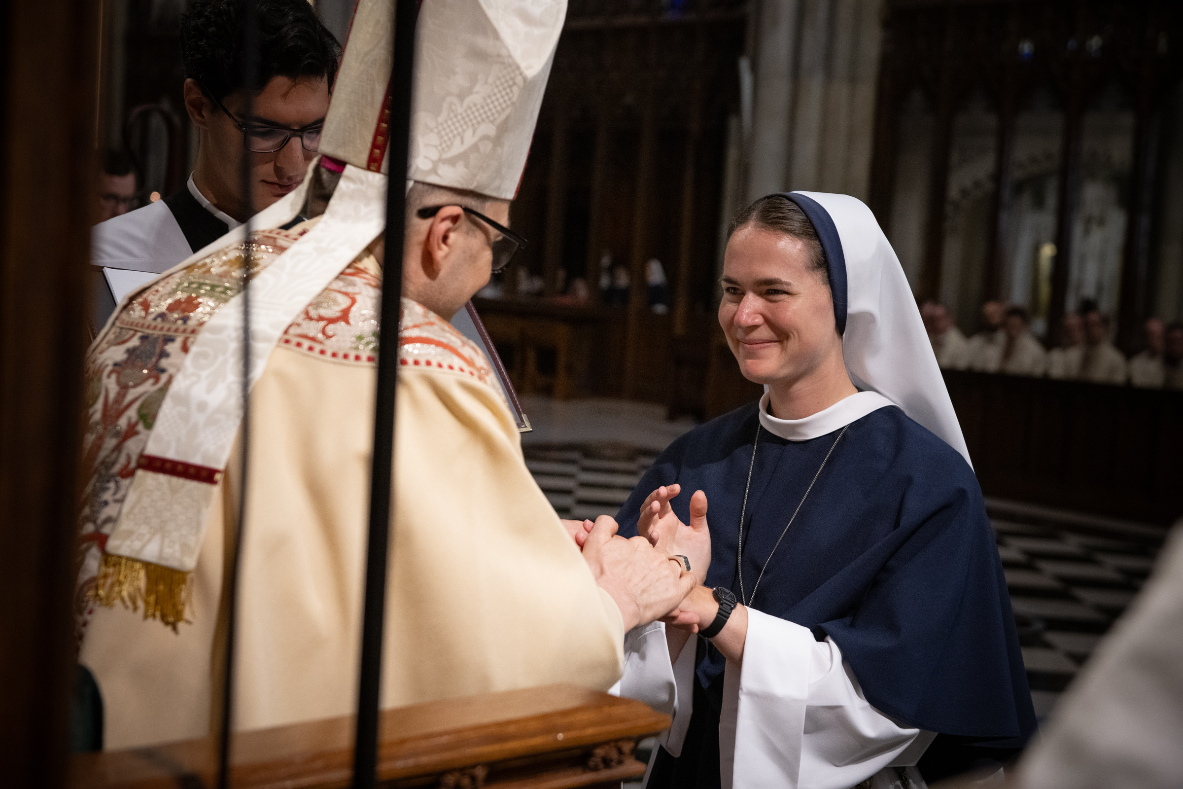 Sister Maria Annunciata, S.V., smiles as Archbishop Hicks completes the presentation of her profession ring.