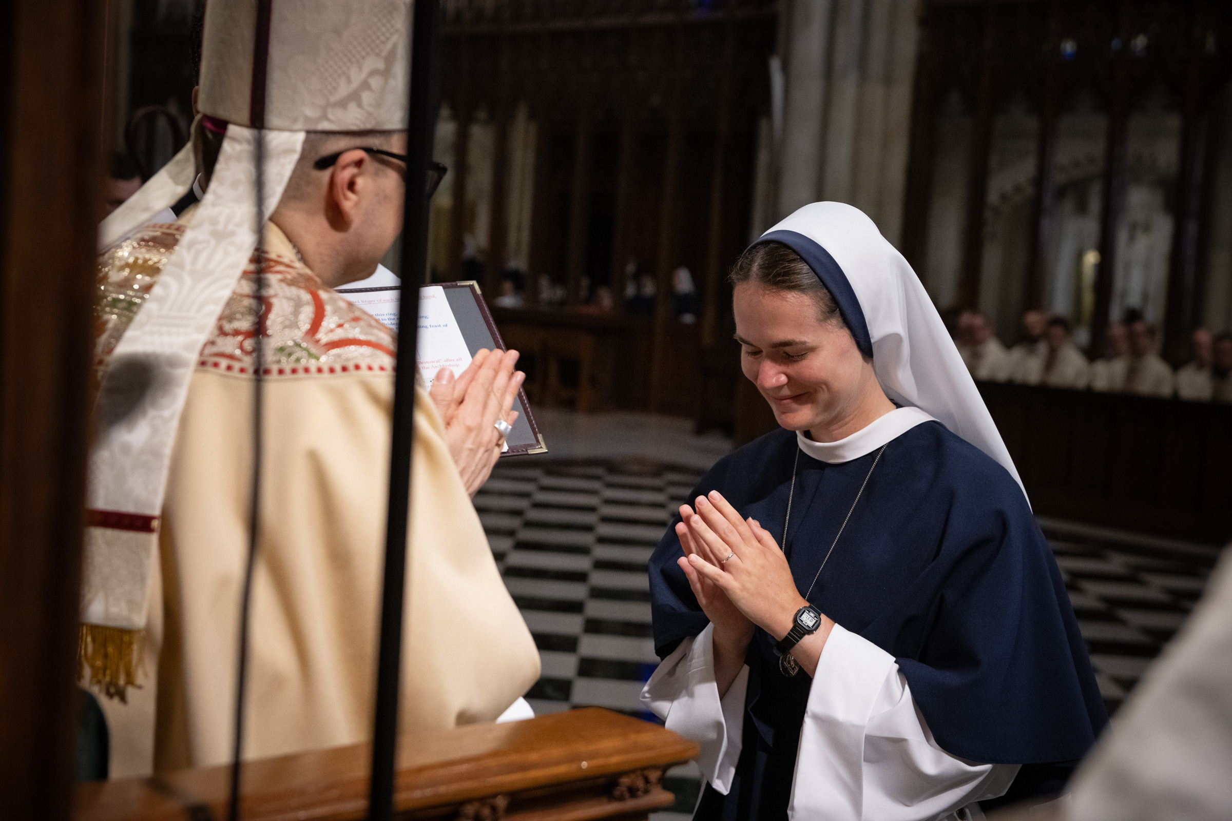 Sister Maria Annunciata, S.V., bows in prayer after receiving her profession ring from Archbishop Hicks.