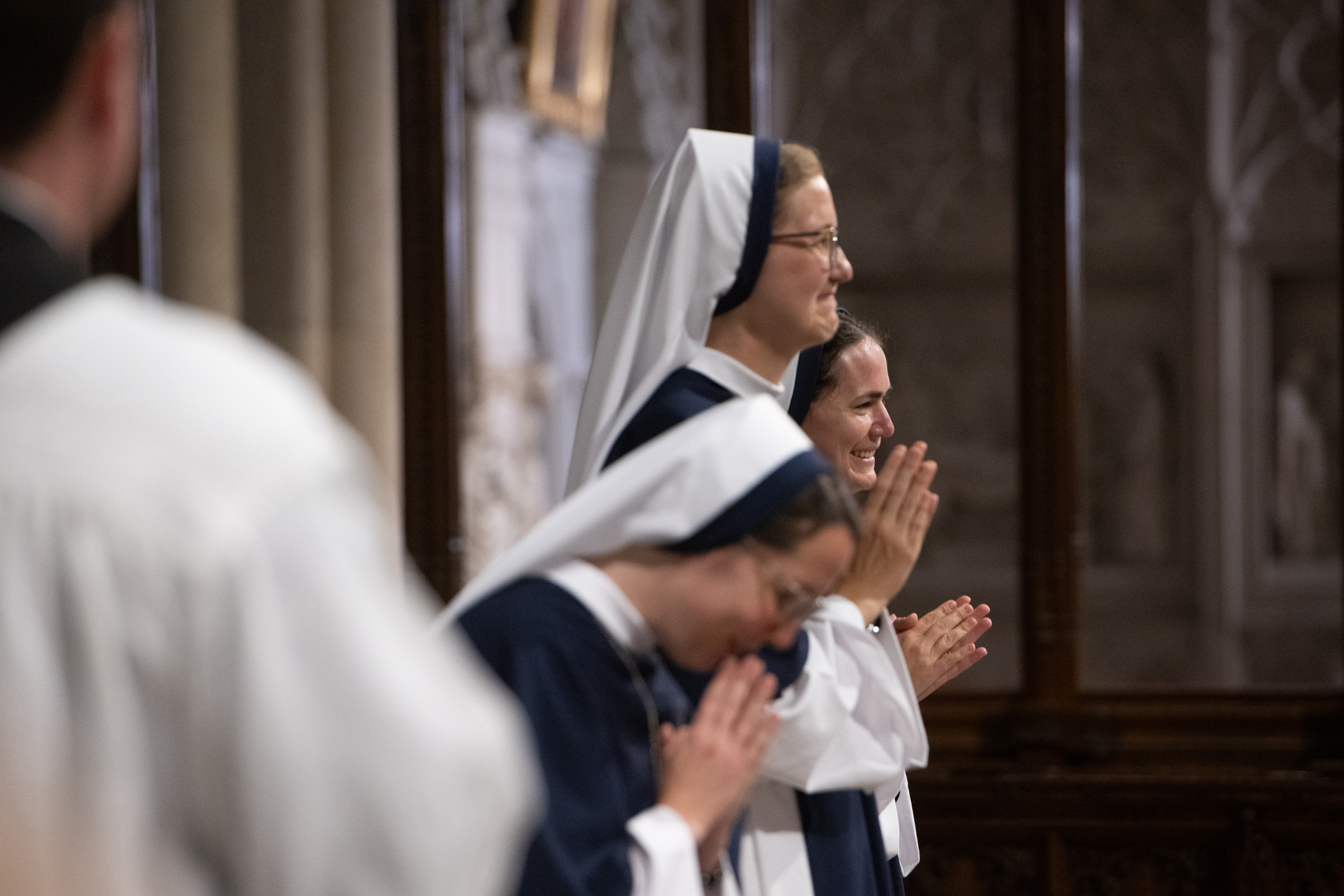 Sister Eden Marie, S.V., Sister Elena Marie, S.V., and Sister Maria Annunciata, S.V., smile and bow together after their profession.