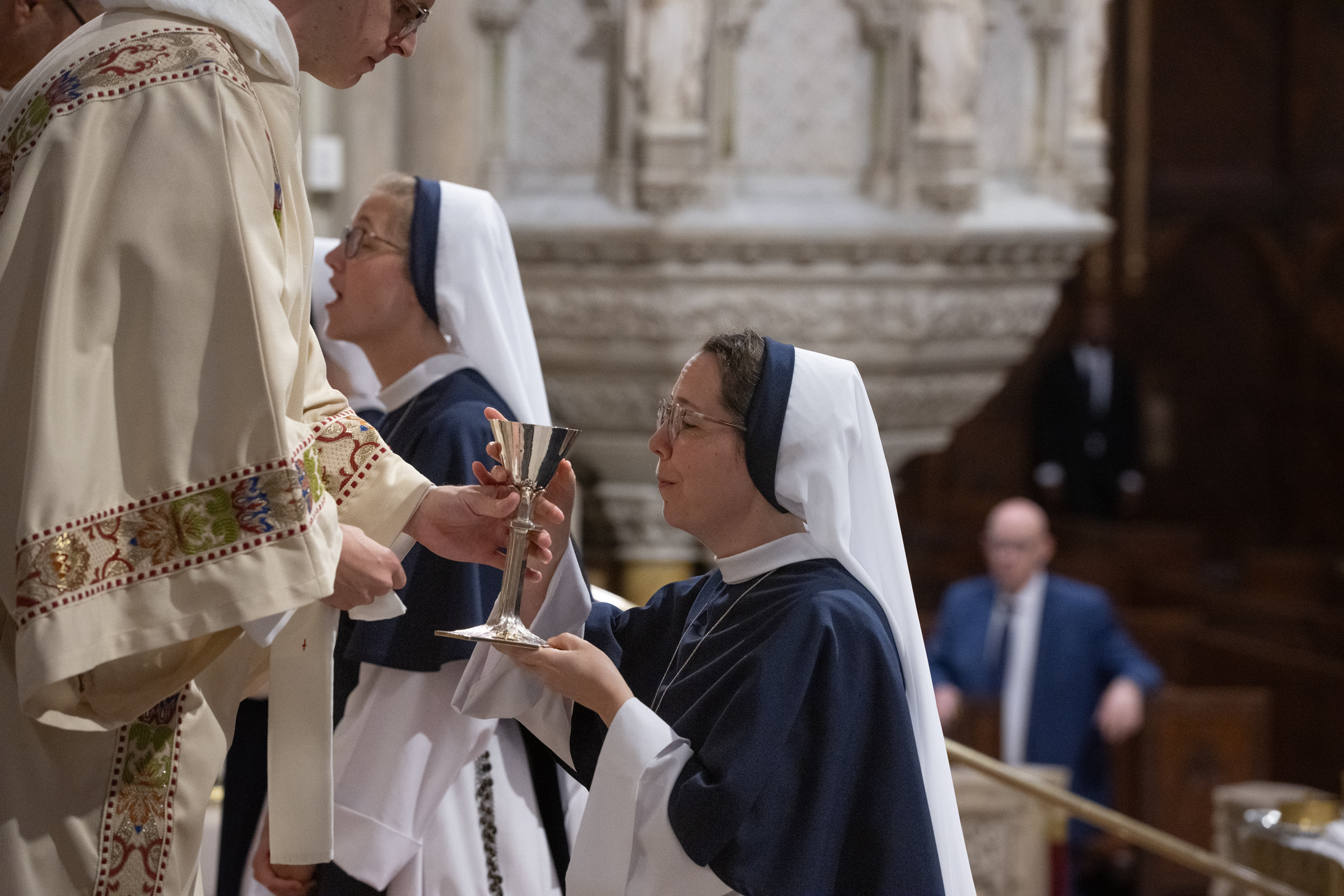 Sister Eden Marie, S.V., receives the chalice during Communion.